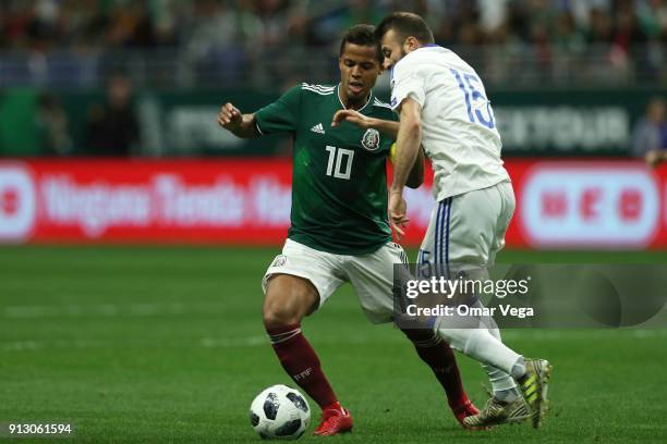 Giovani Dos Santos of Mexico fights for the ball with Elvis Saric of Bosnia and Herzegovina during the friendly match between Mexico and Bosnia and...