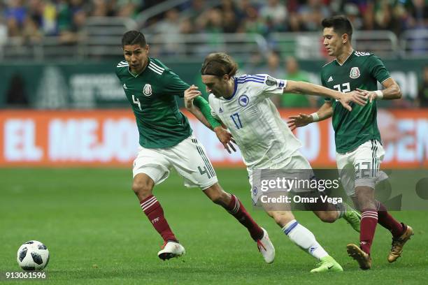 Hugo Ayala of Mexico fights for the ball with Mersudin Ahmetovic of Bosnia and Herzegovina during the friendly match between Mexico and Bosnia and...