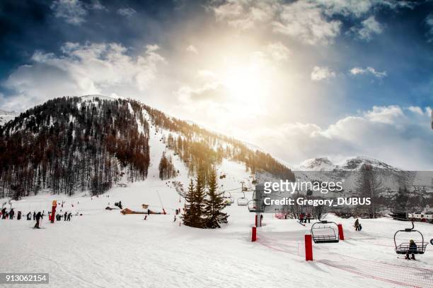 group of tourists skiing and enjoying ski lift in french ski resort of val d'isere - val d'isere stock pictures, royalty-free photos & images