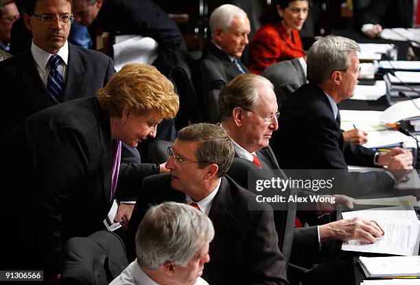 Sen. Debbie Stabenow talks to Sen. Kent Conrad during a mark up hearing before the Senate Finance Committee on Capitol Hill October 1, 2009 in...