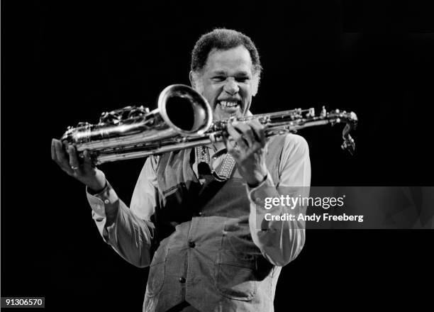 Jazz tenor saxophonist Dexter Gordon raises his instrument, Ann Arbor, MI 1979.