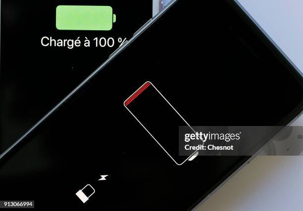 In this photo illustration, Apple mobile phones iPhone 6 on screens of which we can see the battery charge indicator is displayed on February 01,...