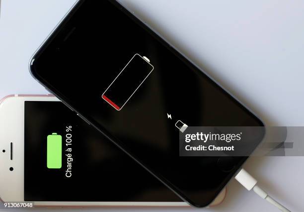 In this photo illustration, Apple mobile phones iPhone 6 on screens of which we can see the battery charge indicator is displayed on February 01,...