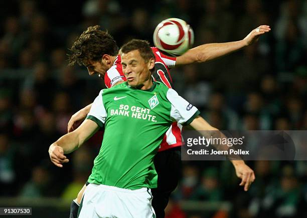 Markus Rosenberg of Bremen and Aitor Ocio of Bilbao battle for the ball during the UEFA Europa League Group L match between SV Werder Bremen and...