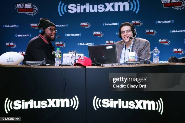 Gerald McCoy of the Tampa Bay Buccaneers and SiriusXM radio host Adam Schein attend SiriusXM at Super Bowl LII Radio Row at the Mall of America on...