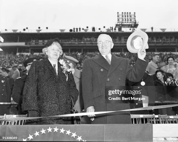 American President Harry Truman and his wife, First Lady Bess Truman greet the crowd before the start of the annual Army-Navy football game, in...