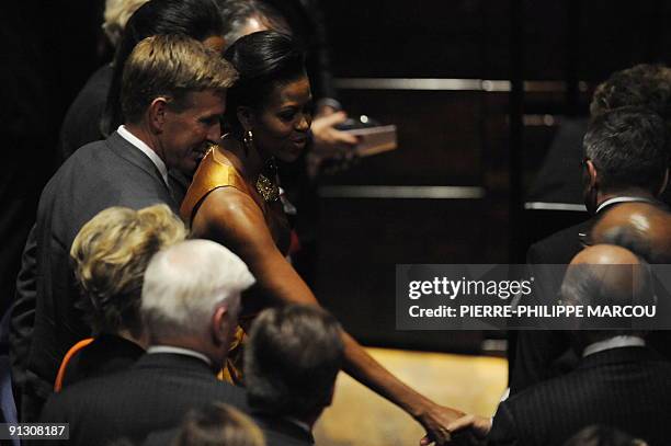 First lady Michelle Obama and Vice President of the international relations for USOC Chicago 2016 Bob Ctvrtlik arrive to the opening ceremony of the...