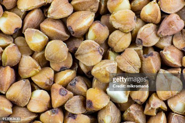 full frame shot of buckwheat grains, macro shot. traditional food. - buckwheat stock pictures, royalty-free photos & images