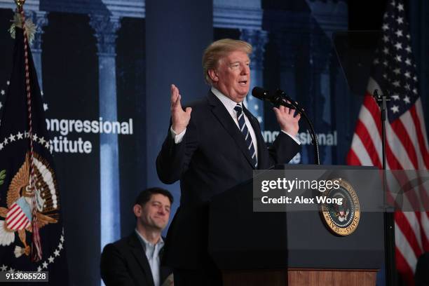 President Donald Trump speaks as Speaker of the House Rep. Paul Ryan listens during a lunch at the 2018 House & Senate Republican Member Conference...