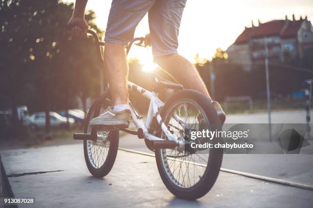 man`s legs on the bmx bicycle - stunt person stock pictures, royalty-free photos & images