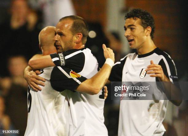 Danny Murphy of Fulham celebrates scoring their first goal with Paul Konchesky and Stephen Kelly during the UEFA Europa League Group H match between...