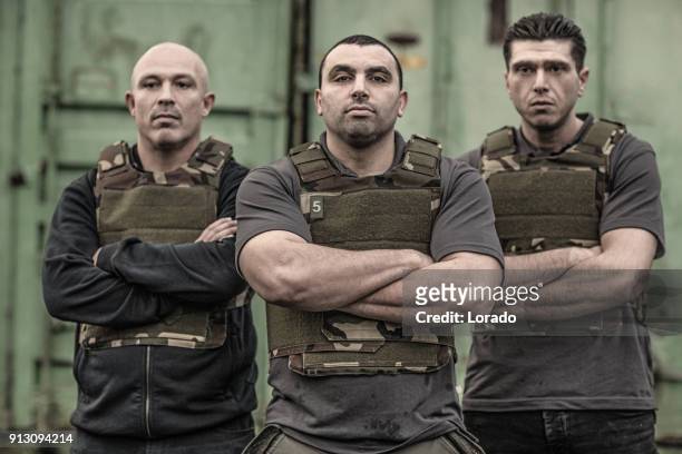 krav maga fighting group posing for team picture in grimy outdoor setting - committee of public security and fight stock pictures, royalty-free photos & images