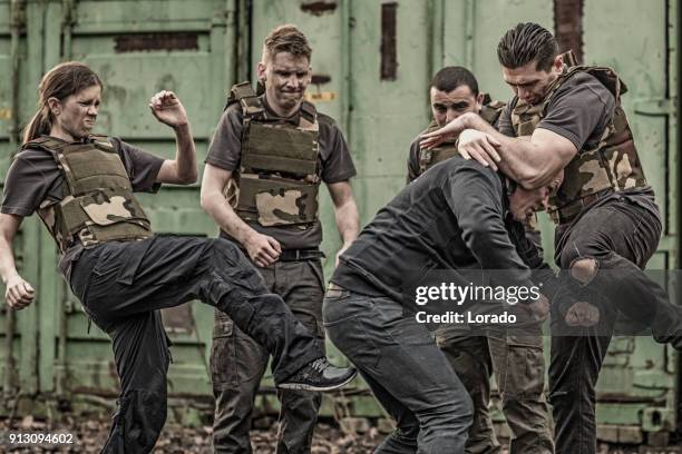 krav maga fighting group sparring during training session in grimy outdoor setting - committee of public security and fight stock pictures, royalty-free photos & images