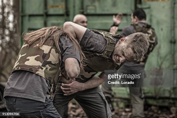 krav maga fighting group sparring during training session in grimy outdoor setting - committee of public security and fight stock pictures, royalty-free photos & images