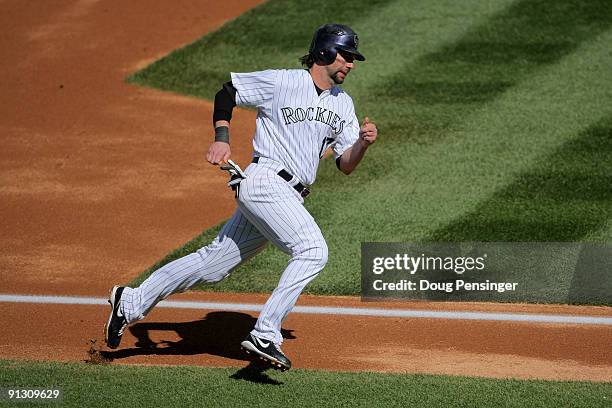 Todd Helton of the Colorado Rockies rounds third to score on an RBI single by Garrett Atkins off of starting pitcher Manny Parra of the Milwaukee...