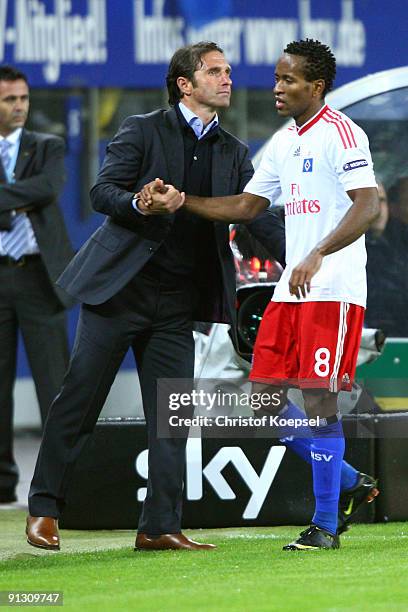 Head coach Bruno Labbadia of Hamburg shakes hand with Zé Roberto of Hamburg after his substitution during the Europa League first leg match between...