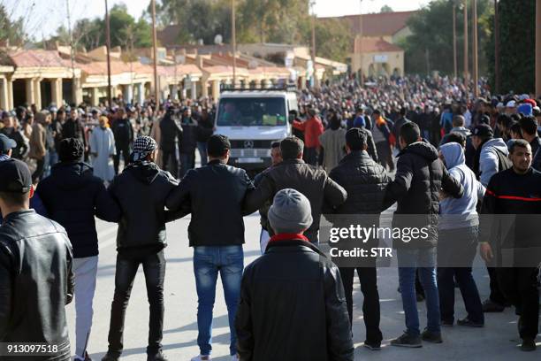 Moroccan mourners stand in a vigil during the funeral of a miner who died in an accident in a disused coal mine in the northeastern city of Jerada,...