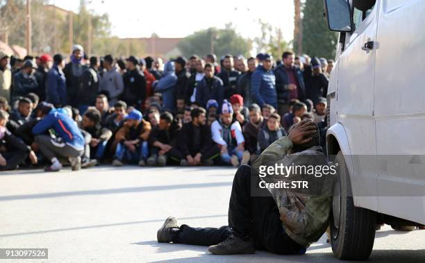 Moroccan mourns with others during the funeral of a miner who died in an accident in a disused coal mine in the northeastern city of Jerada, 60...