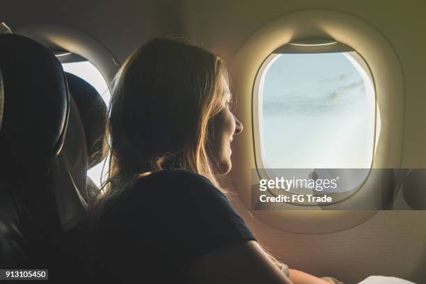 young woman travelling with airplane - inside of airplane stock pictures, royalty-free photos & images