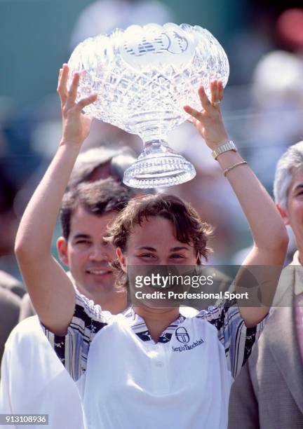 Martina Hingis of Switzerland lifts the trophy after defeating Monica Seles of the USA in the Women's Singles Final of the Lipton International...