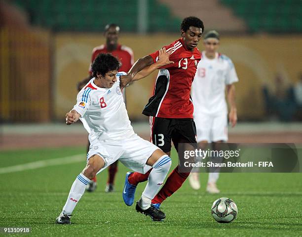 Juma Clarence of Trinidad and Tobago is challenged by Hernan Perez of Paraquay during the FIFA U20 World Cup Group A match between Trinidad and...