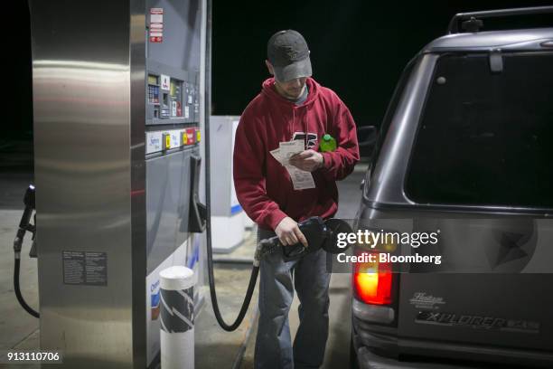 Customer pumps fuel into a vehicle at a Chevron Corp. Gas station in Eastanollee, Georgia, U.S., on Monday, Jan. 29, 2018. Chevron Corp. Is scheduled...