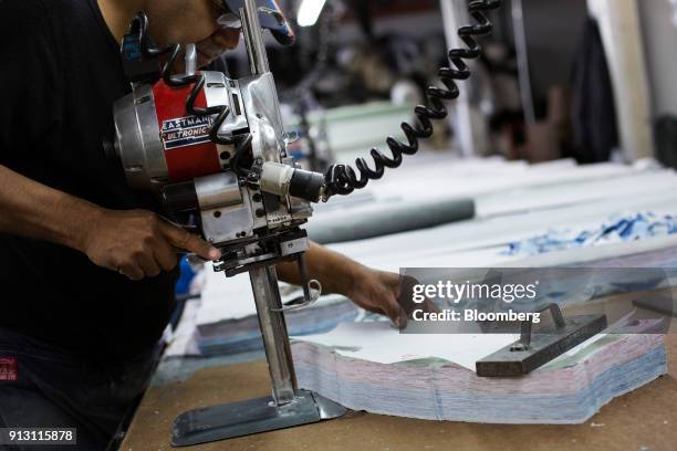 An employee prepares fabric for jeggings at the 9B Apparel manufacturing facility in Los Angeles, California, U.S., on Wednesday, Jan. 17, 2018. The...