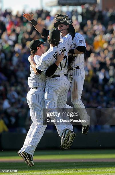 Ian Stewart, Todd Helton and Troy Tulowitzki of the Colorado Rockies celebrate after the final out as they defeated the Milwaukee Brewers 9-2 and...