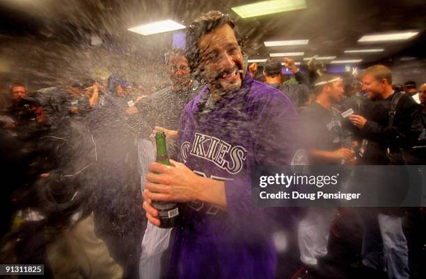 Joe Beimel is sprayed with champagne by Jason Hammel of the Colorado Rockies as they celebrate in the clubhouse after they defeated the Milwaukee...