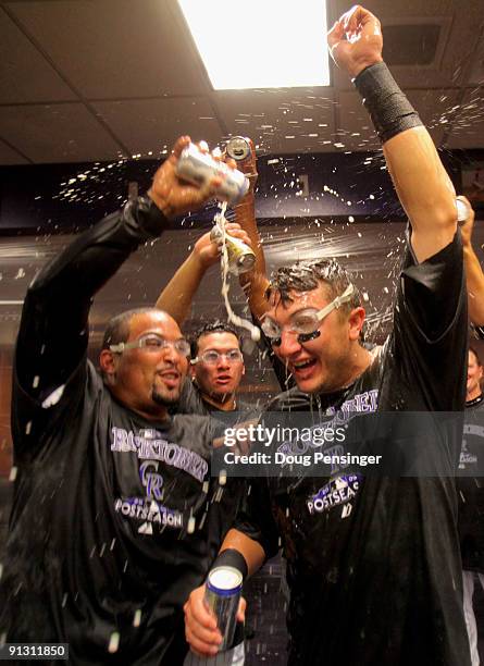 Yorvit Torrealba and Troy Tulowitzki of the Colorado Rockies celebrate in the clubhouse after they defeated the Milwaukee Brewers 9-2 and clinched a...