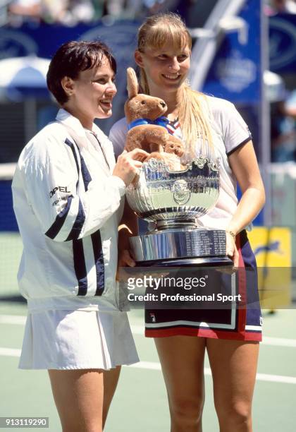 Doubles partners Martina Hingis of Switzerland and Mirjana Lucic of Croatia pose with the trophy after defeating Lindsay Davenport of the USA and...