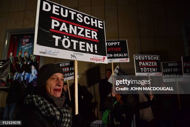 Activists of Campact, Urgewald and Adopt a Revolution display placards calling on Germany to hold weapons exports to Turkey in front of the Bavarian...