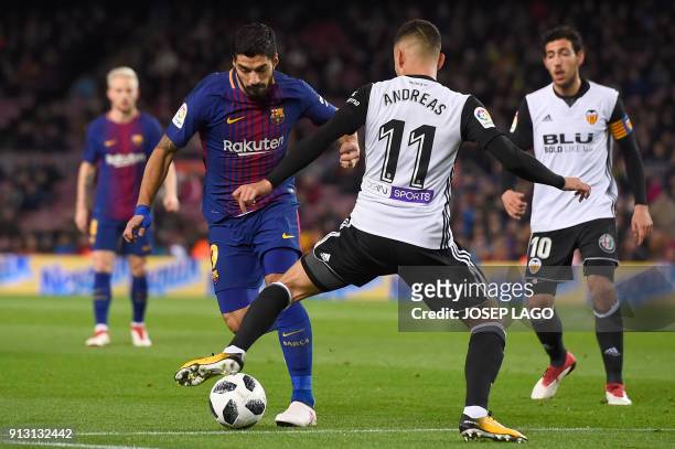 Barcelona's Uruguayan forward Luis Suarez vies with Valencia's Brazilian forward Andreas Pereira during the Spanish 'Copa del Rey' first leg...