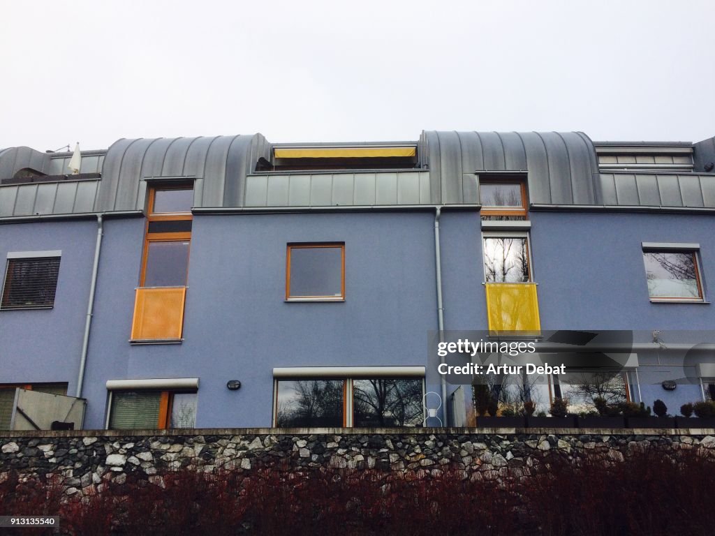 Semi-detached house with modern architecture and round shape cover made of zinc in the city of Prague.