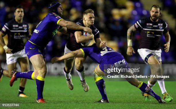 Leeds Rhino's Brad Dwyer is tackled by Warrington's Chris Hill and Ben Westwood during the Betfred Super League match at the Halliwell Jones Stadium,...