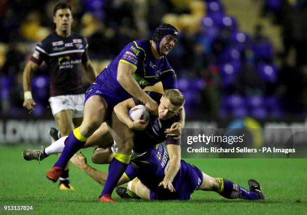 Leeds Rhino's Brad Dwyer is tackled by Warrington's Chris Hill and Ben Westwood during the Betfred Super League match at the Halliwell Jones Stadium,...