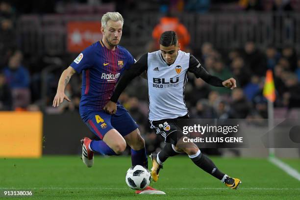 Barcelona's Croatian midfielder Ivan Rakitic vies for the ball with Valencia's Brazilian forward Andreas Pereira during the Spanish 'Copa del Rey'...