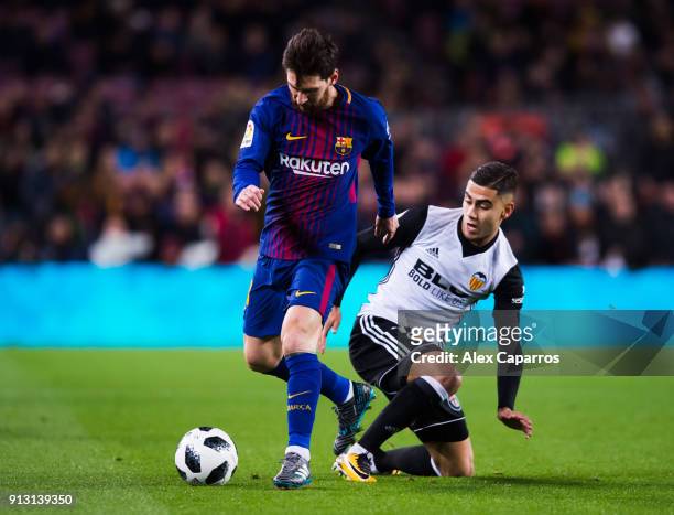 Lionel Messi of FC Barcelona dribbles Andreas Pereira of Valencia CF during the Copa del Rey semi-final first leg match between FC Barcelona and...