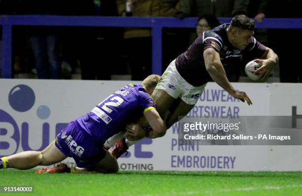 Leeds Rhino's Ryan Hall dives over to score as Warrington's Jack Hughes tackles during the Betfred Super League match at the Halliwell Jones Stadium,...