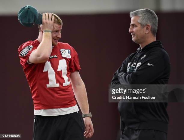 Carson Wentz of the Philadelphia Eagles speaks with offensive coordinator Frank Reich during Super Bowl LII practice on February 1, 2018 at the...