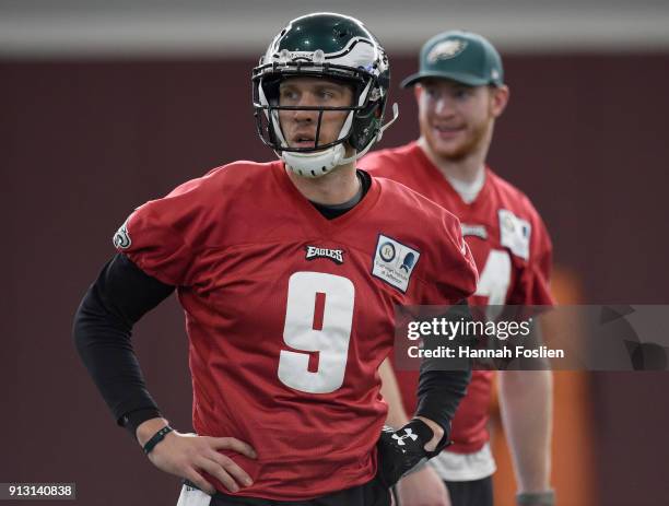 Nick Foles and Carson Wentz of the Philadelphia Eagles look on during Super Bowl LII practice on February 1, 2018 at the University of Minnesota in...