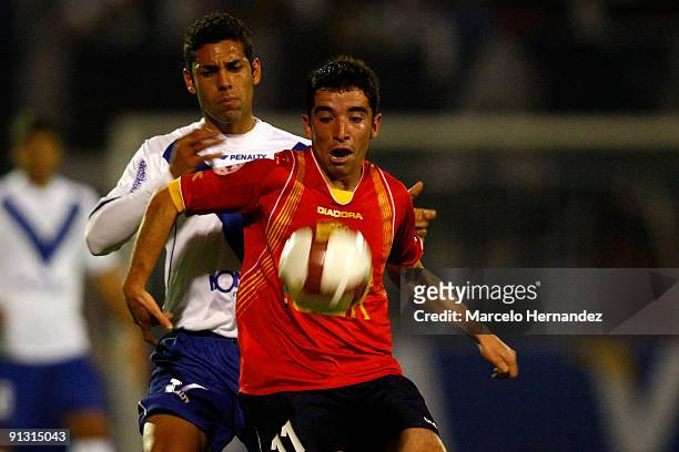 Franco Razzoti of Argentina's Velez Sarsfield vies for the ball with Fernando Cordero of Chile's Union Espanola during their second match as part of...