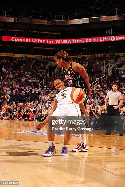 Temeka Johnson of the Phoenix Mercury is fouled by Tamika Catchings of the Indiana Fever in Game Two of the WNBA Finals on October 1, 2009 at U.S....