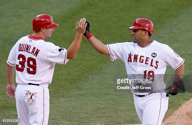 Robb Quinlan of the Los Angeles Angels of Anaheim congratulates Kendry Morales after Morales' two-run home run against the Texas Rangers in the third...