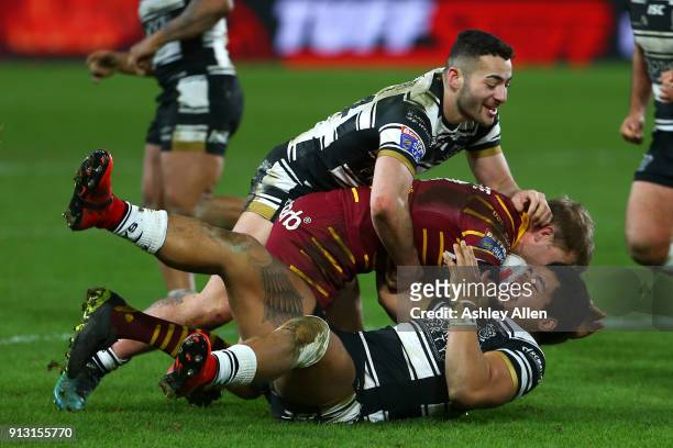 Mark Minichiello and Fetuli Talanoa of Hull FC tackle Ryan Hinchcliffe of Huddersfield Giants during the BetFred Super League match between Hull FC...
