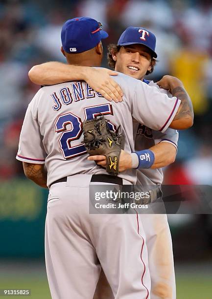 Andruw Jones and Ian Kinsler of the Texas Rangers congratulate one another following their victory over the Los Angeles Angels of Anaheim at Angel...