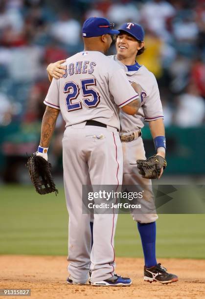 Andruw Jones and Ian Kinsler of the Texas Rangers congratulate one another following their victory over the Los Angeles Angels of Anaheim at Angel...