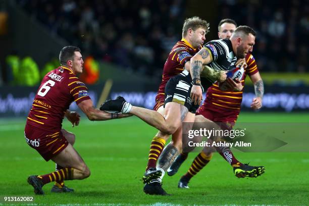 Josh of Hull FC attempts to get away from Lee Gaskell and Jordan Rankin of Huddersfield Giants during the BetFred Super League match between Hull FC...