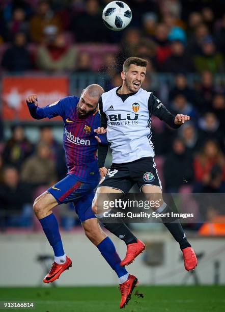 Aleix Vidal of Barcelona competes for the ball with Jose Luis Gaya of Valencia during the Copa del Rey semi-final first leg match between FC...