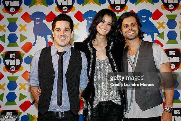 Model Carol Ribeiro and Rogerio Flausino and Marco Tulio of the band J Quest pose for a photograph during the MTV's Video Music Brazil Awards 2009 at...